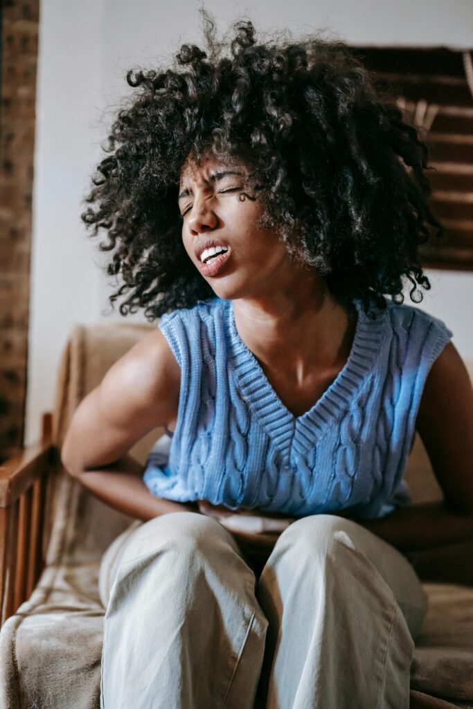 A female holding her stomach in pain